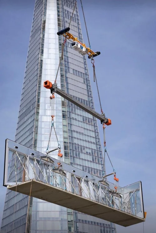 Vita Load Navigator guiding a suspended platform beside a high-rise building