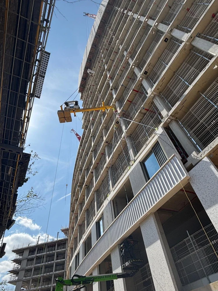 RocketLever positioning a suspended balcony alongside a high-rise building