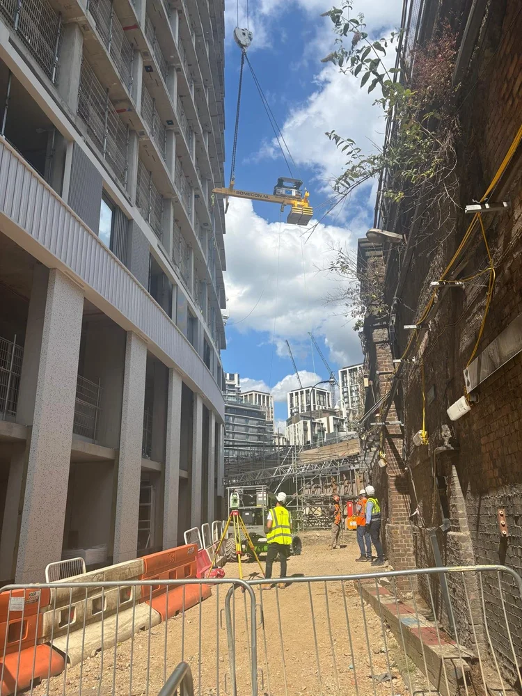 RocketLever operating between a high-rise building and an adjacent brick building